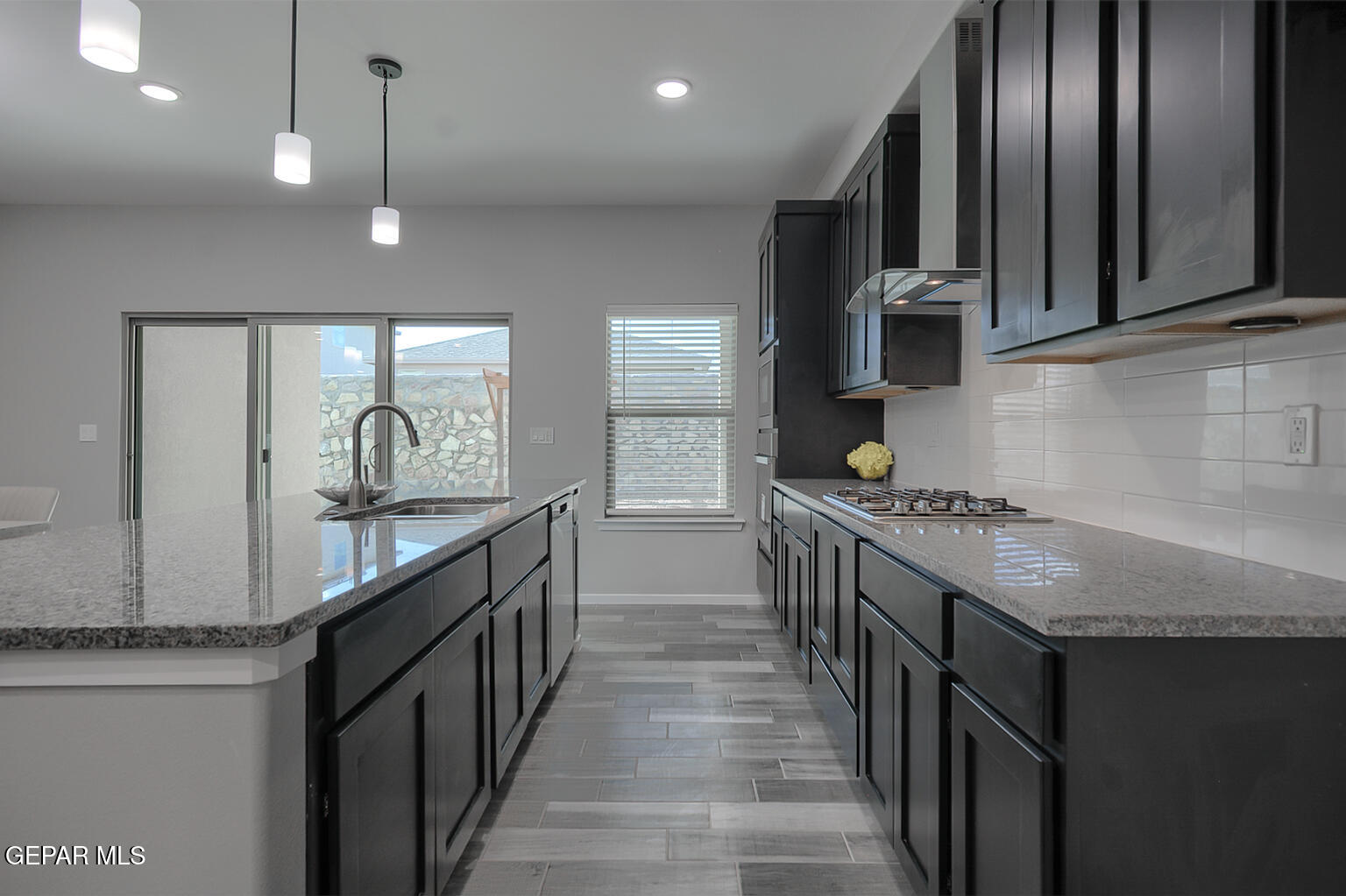 13896 Sky Ranger Avenue El Paso, TX 79928 - Photo 13 of 30 a kitchen with granite countertop a sink stove and cabinets