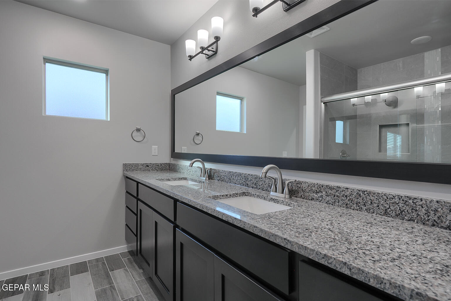 13896 Sky Ranger Avenue El Paso, TX 79928 - Photo 24 of 30 a bathroom with a granite countertop sink a large mirror and vanity