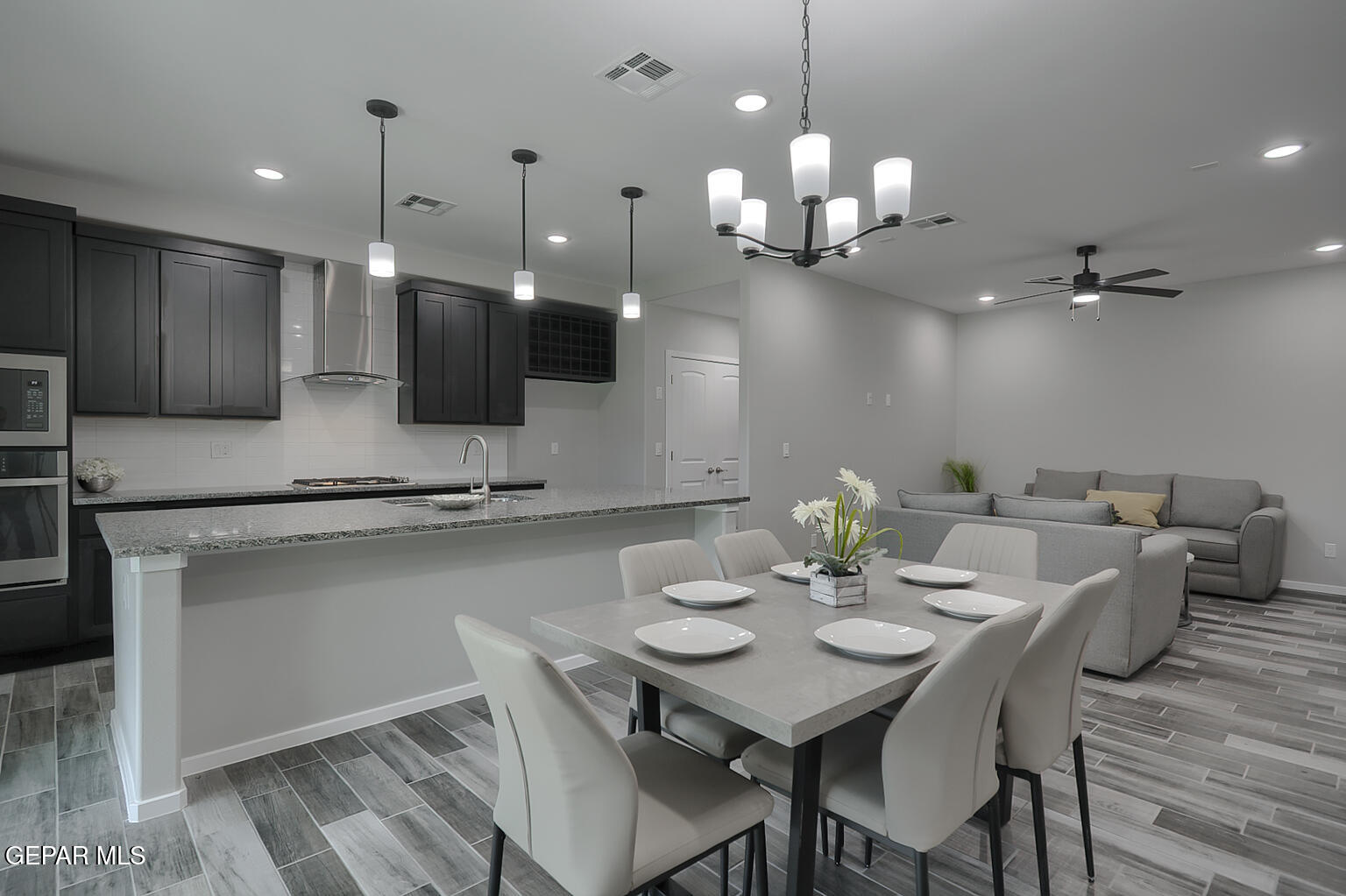 13896 Sky Ranger Avenue El Paso, TX 79928 - Photo 9 of 30 a kitchen with a dining table chairs and microwave