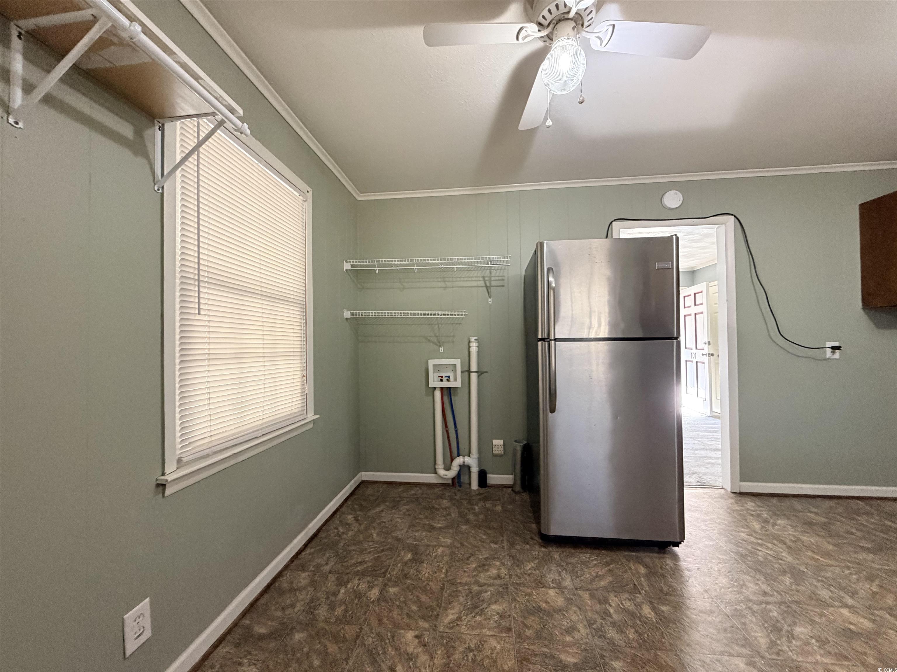 107 Aster Drive Greer, SC 29651 - Photo 7 of 20 Kitchen featuring ornamental molding, freestanding refrigerator, ceiling fan, and stone finish floors
