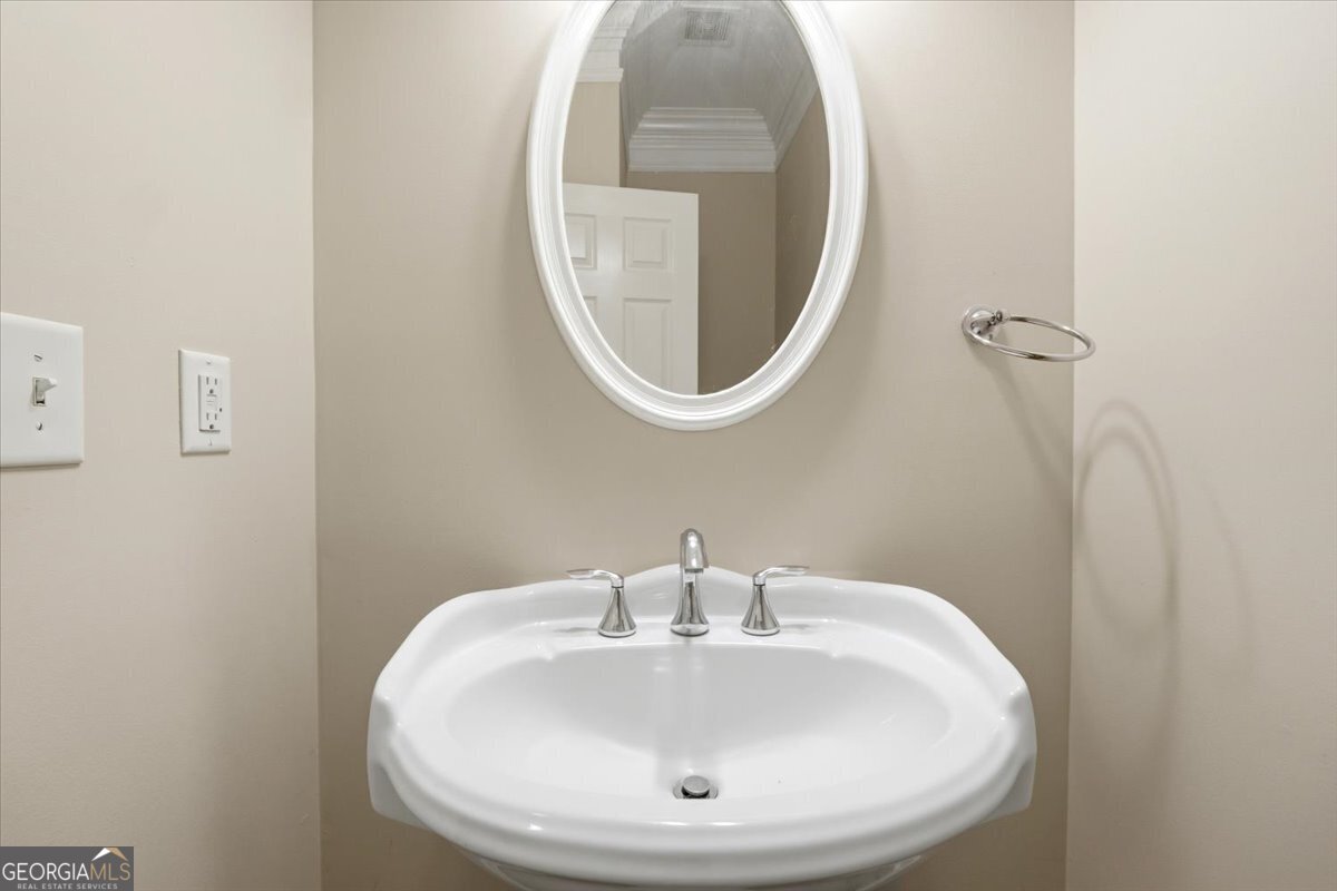 728 Markhams Drive Madison, GA 30650 - Photo 13 of 51 a bathroom with a sink and a mirror