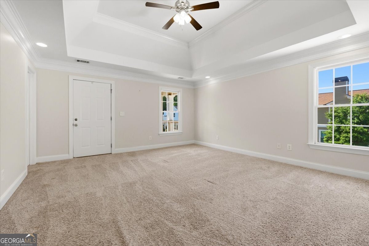 728 Markhams Drive Madison, GA 30650 - Photo 21 of 51 an empty room with windows and fan