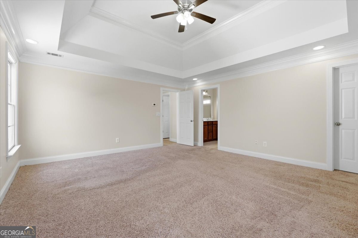 728 Markhams Drive Madison, GA 30650 - Photo 22 of 51 a view of an empty room with a ceiling fan