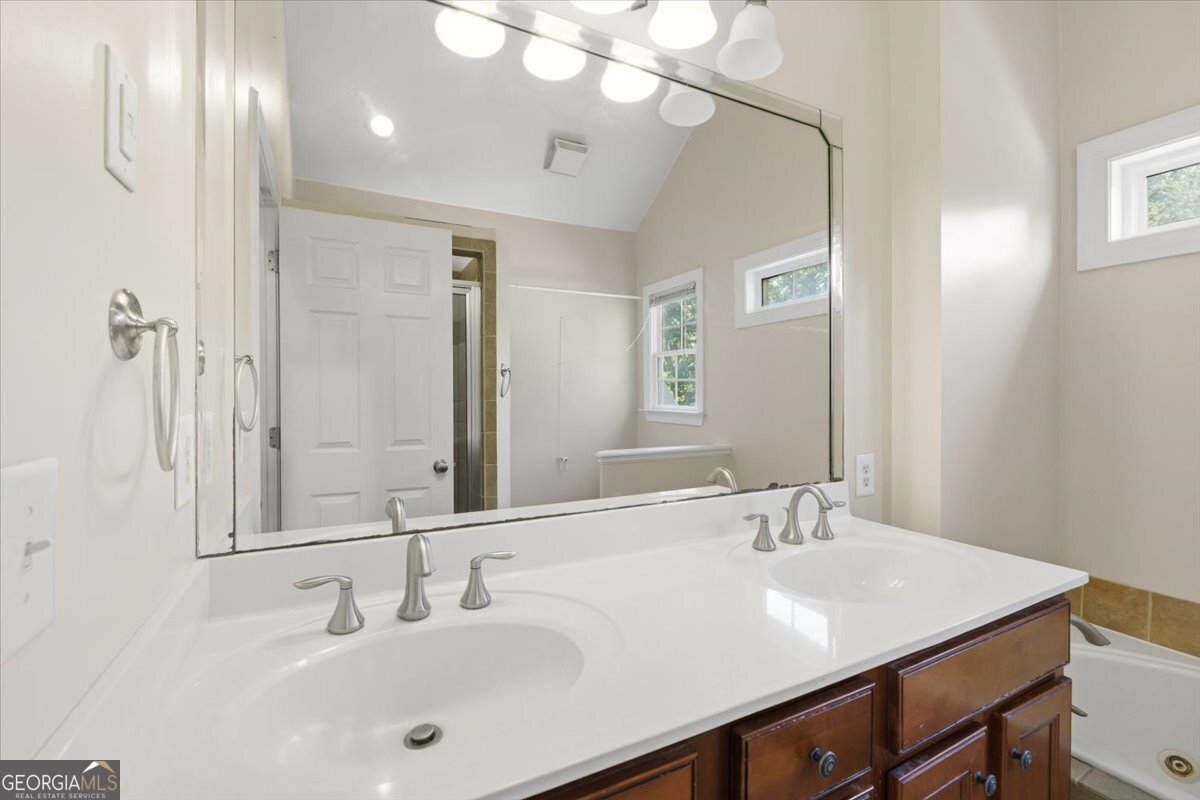 728 Markhams Drive Madison, GA 30650 - Photo 23 of 51 a bathroom with a sink double vanity and a mirror