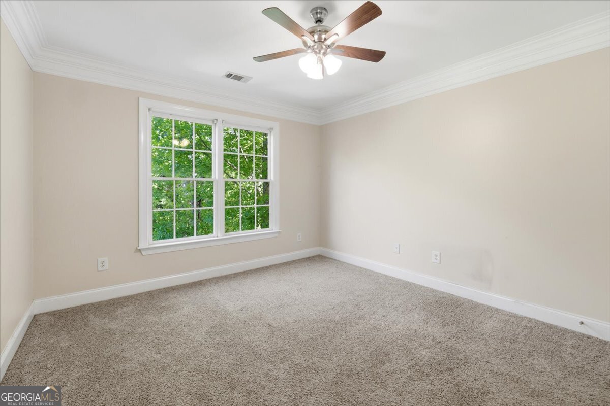 728 Markhams Drive Madison, GA 30650 - Photo 26 of 51 an empty room with a window and a fan