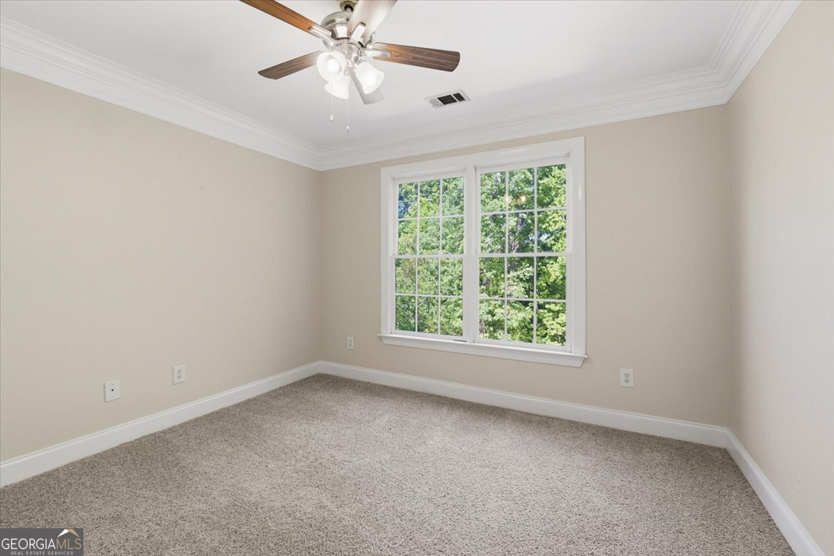 728 Markhams Drive Madison, GA 30650 - Photo 29 of 51 an empty room with a window and a fan