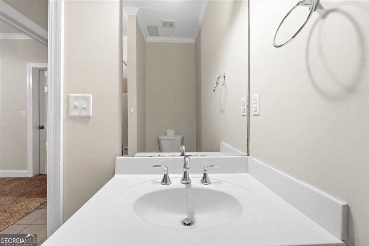 728 Markhams Drive Madison, GA 30650 - Photo 31 of 51 a bathroom with a sink and a mirror