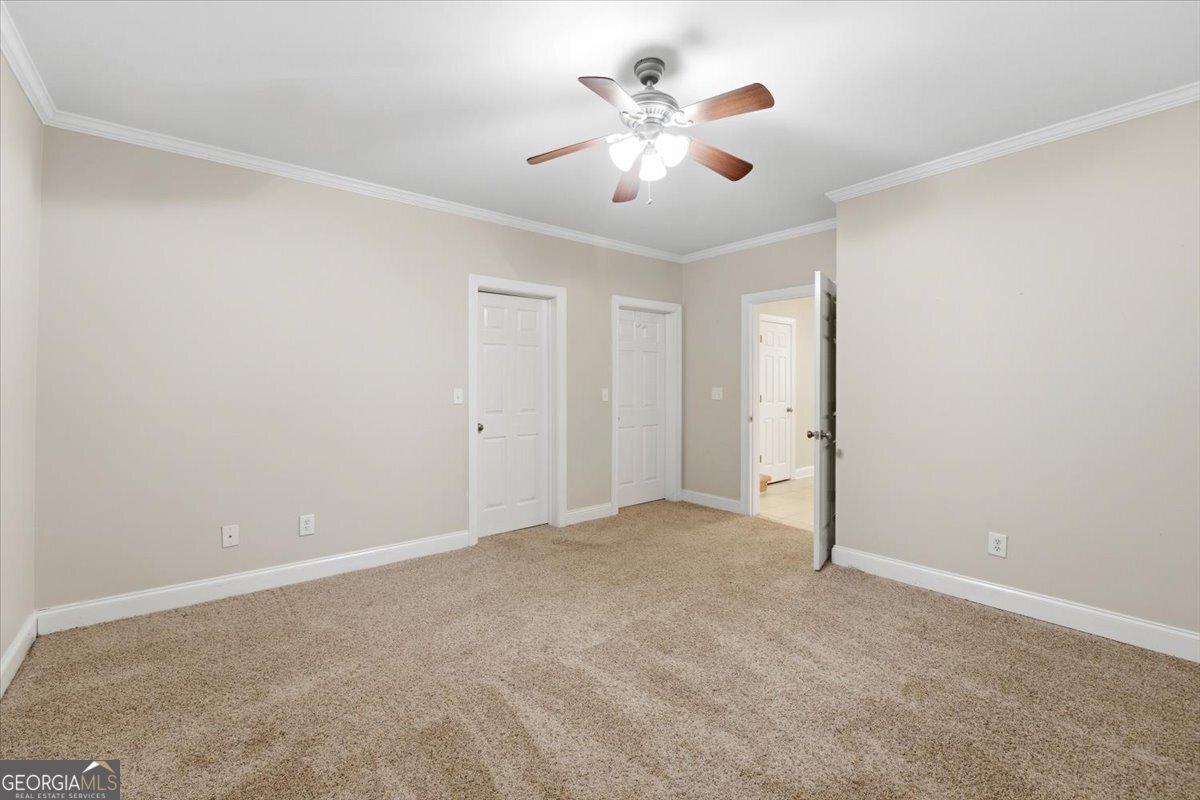 728 Markhams Drive Madison, GA 30650 - Photo 36 of 51 a view of an empty room with a chandelier fan