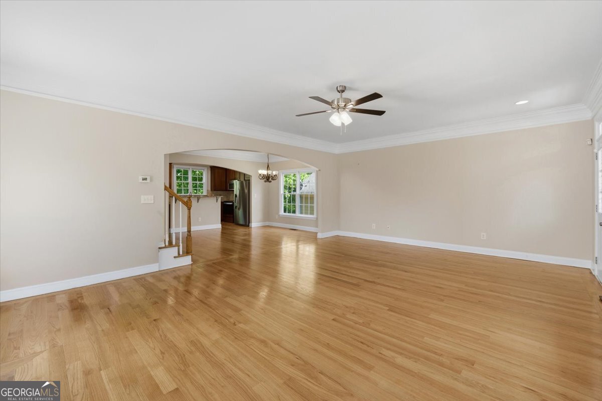 728 Markhams Drive Madison, GA 30650 - Photo 4 of 51 a view of an empty room with window and wooden floor
