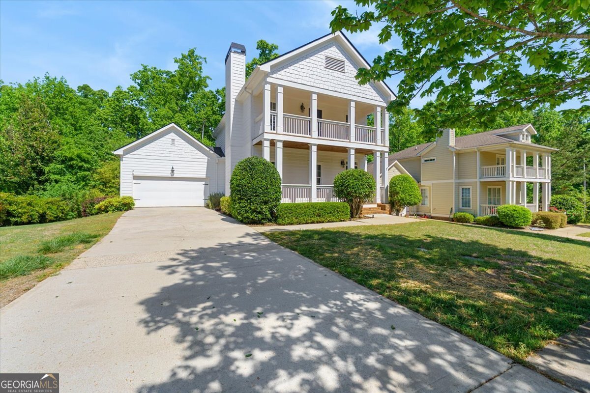728 Markhams Drive Madison, GA 30650 - Photo 46 of 51 a front view of a house with a yard and potted plants