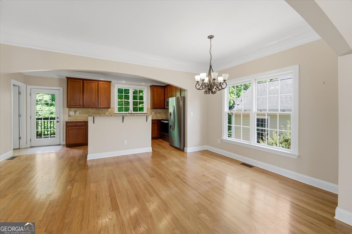 728 Markhams Drive Madison, GA 30650 - Photo 6 of 51 a view of a room with wooden floor fireplace and windows