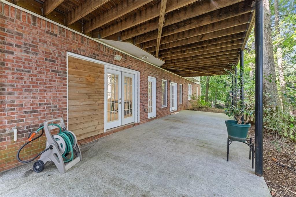 1040 Auburn Road Dacula, GA 30019 - Photo 37 of 42 a view of a porch with furniture and floor to ceiling window