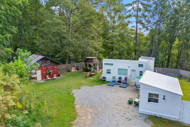 a view of a house with backyard and sitting area