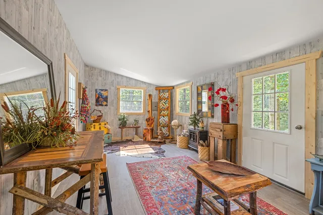 a kitchen that has a lot of cabinets a sink and wooden floor