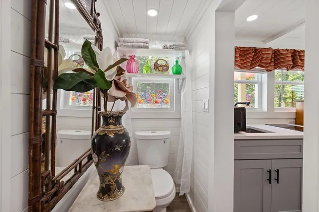 a view of a patio with table and chairs potted plants with wooden fence