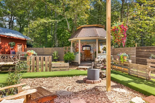 a view of backyard with barbeque grill and a small yard