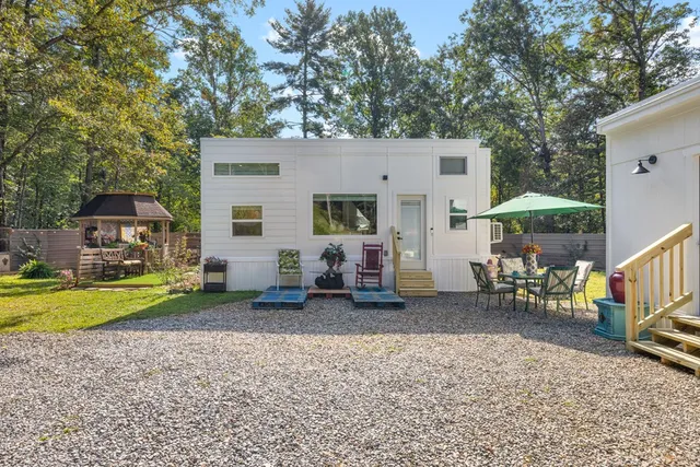 a view of a house with swimming pool and sitting area