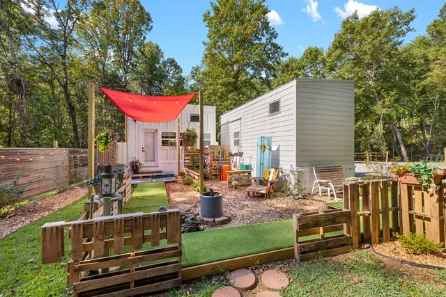 a backyard of a house with barbeque oven table and chairs