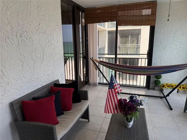 a living room with furniture a rug and a window