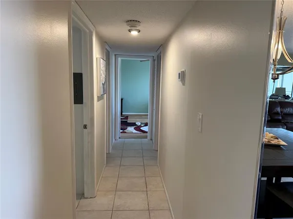 a view of a hallway and a livingroom with furniture
