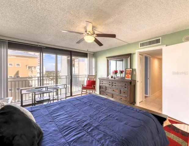 a bedroom with a large bed and a large window