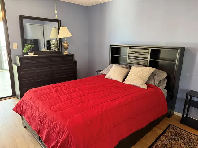 a bedroom with a bed and a mirror