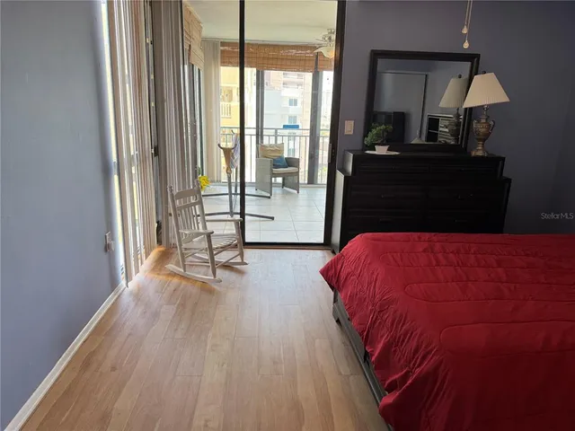 a living room with a bed furniture and a large window