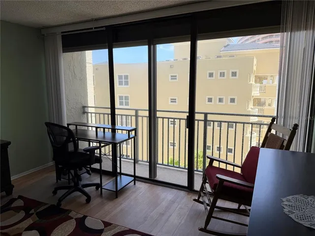 a view of a workspace with furniture and a window