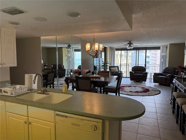 a kitchen with a dining table cabinets and window