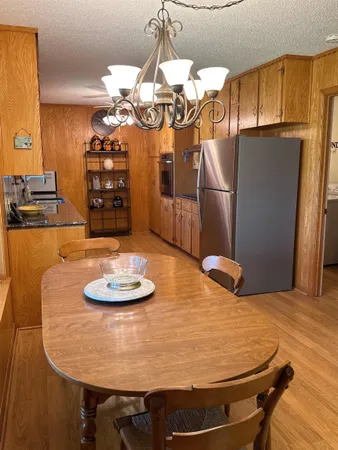 a kitchen with stainless steel appliances granite countertop a sink a refrigerator and a stove