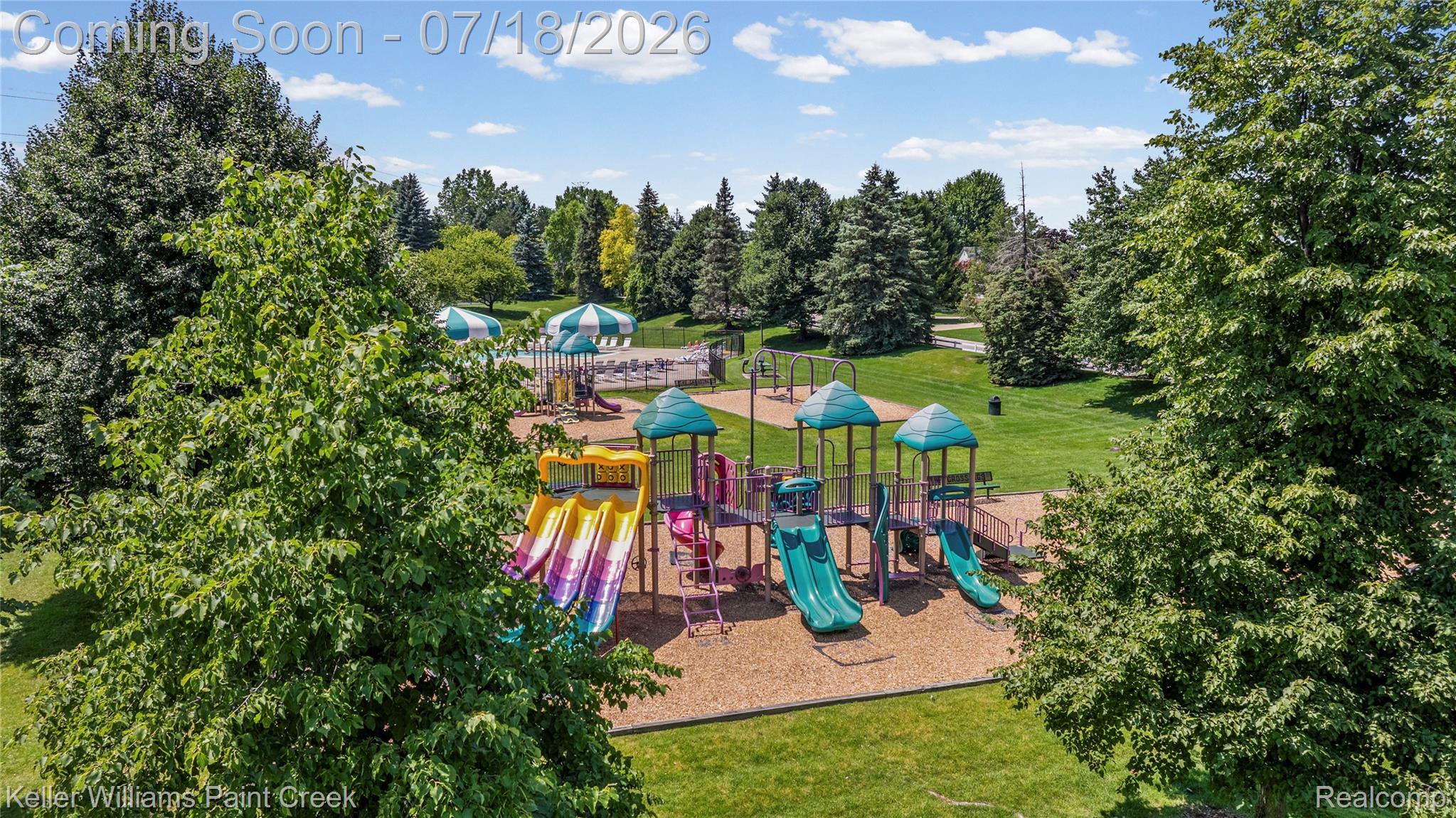 4230 Holly Lane Rochester, MI 48306 - Photo 59 of 64 Community playground featuring multiple play structures, slides, and swings