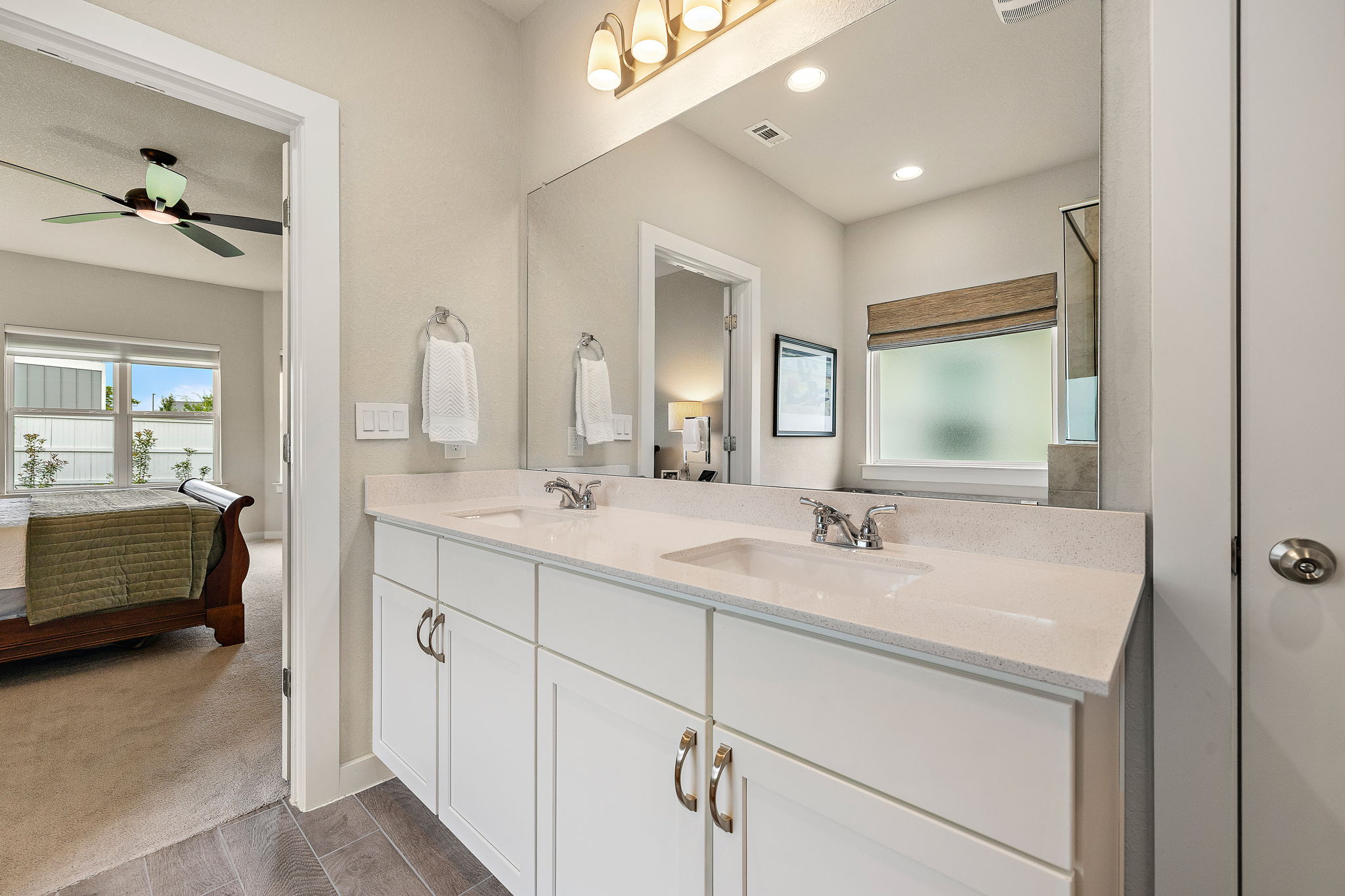 234 Appleberry Lane Elgin, TX 78621 - Photo 21 of 28 Dual sinks and a wide vanity give the primary ensuite a polished, practical setup for daily routines.