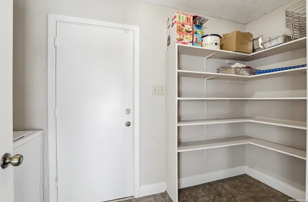 a view of a dining room with furniture and a window