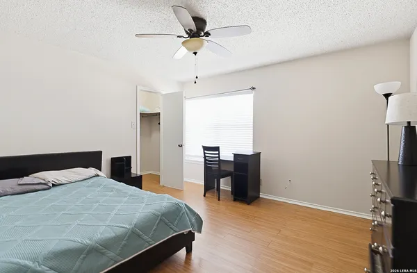 a bathroom with a bathtub shower sink vanity and toilet
