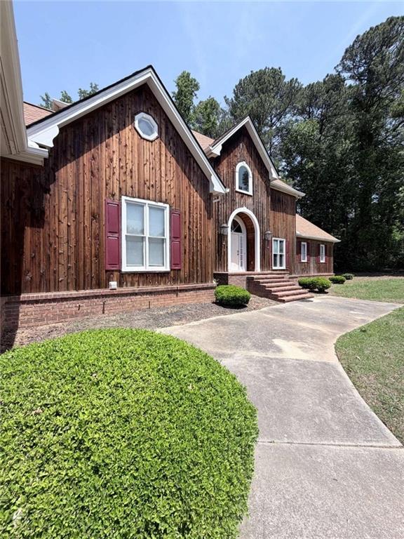 763 McDaniel Mill Road Southwest Conyers, GA 30094 - Photo 3 of 80 a front view of a house with a yard