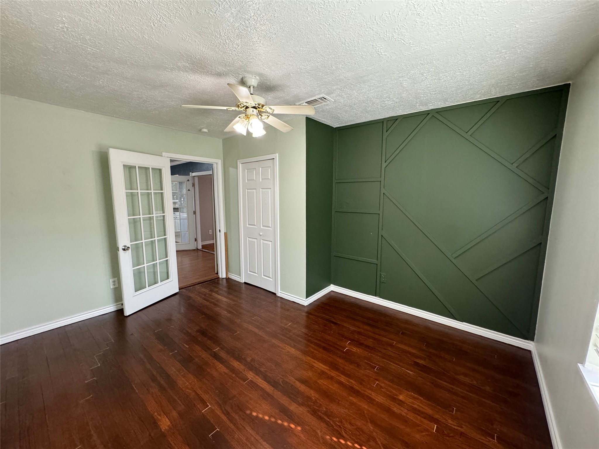 125 Pomeroy Street Pasadena, TX 77506 - Photo 12 of 19 wooden floor in an empty room with a window
