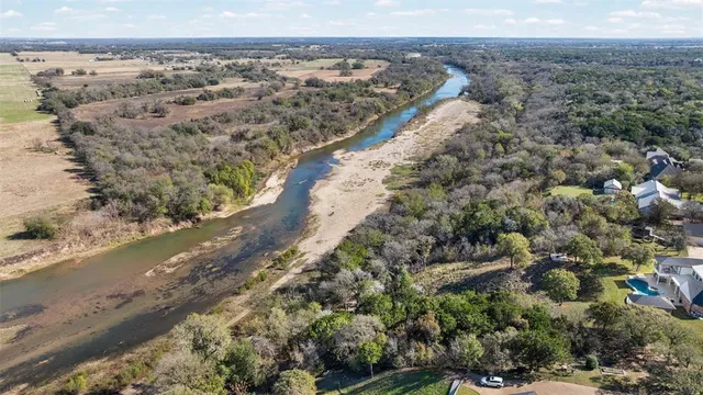 a view of a hallway with windows chandelier and glass door