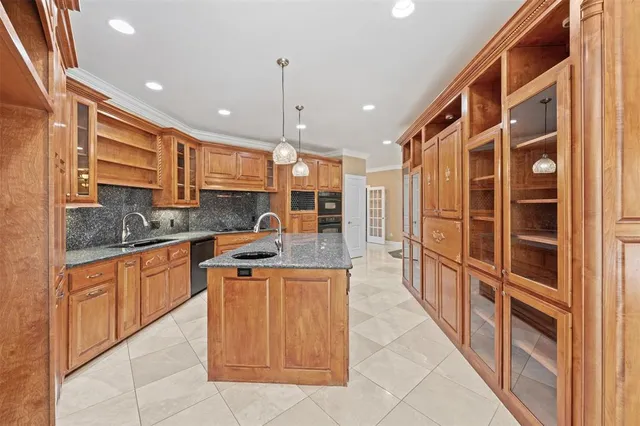 a kitchen with stainless steel appliances granite countertop a stove a sink and a refrigerator