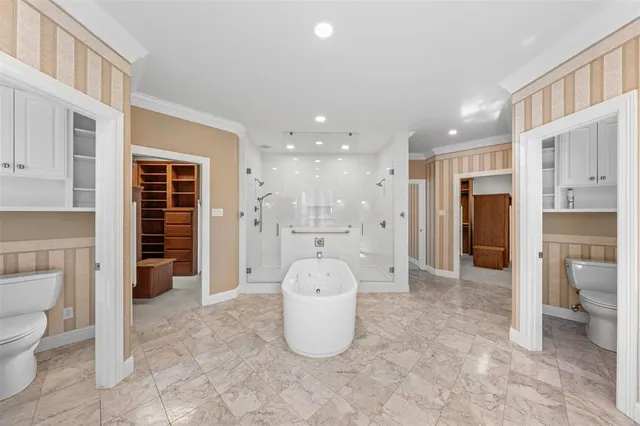 a large spacious bathroom with a large tub shower and sink