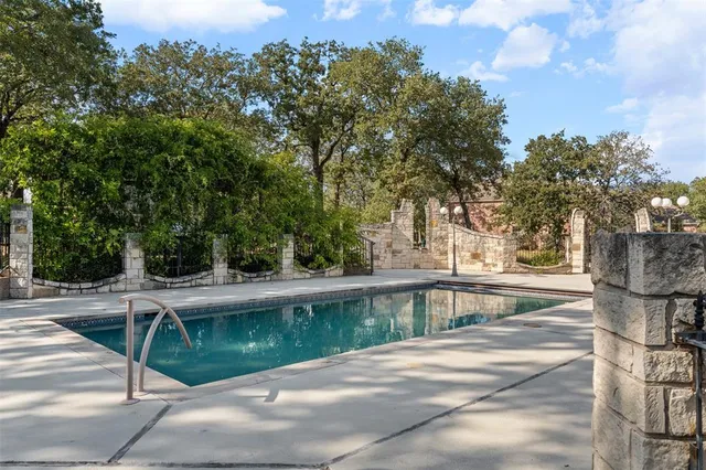 a view of a swimming pool with a yard