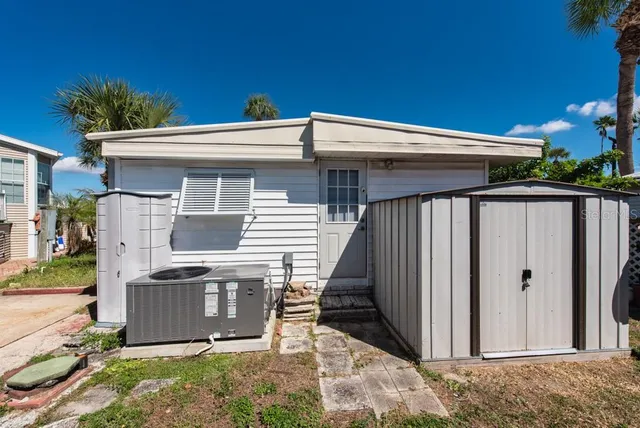 a view of a house with potted plants in front of main door