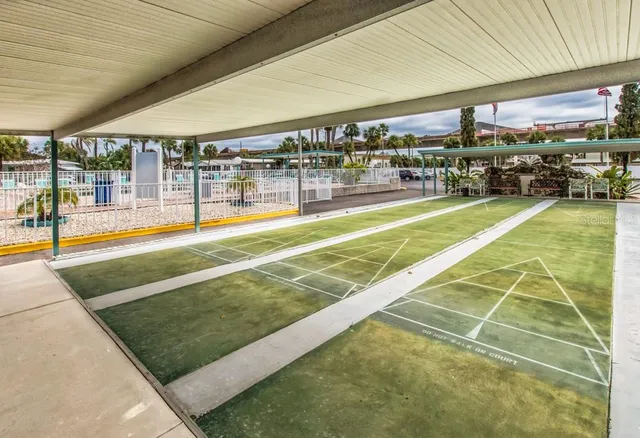 a dining hall with lots of tables a large window and chairs