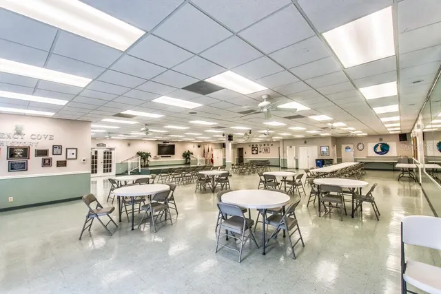 a view of a dining room with furniture and a book shelf