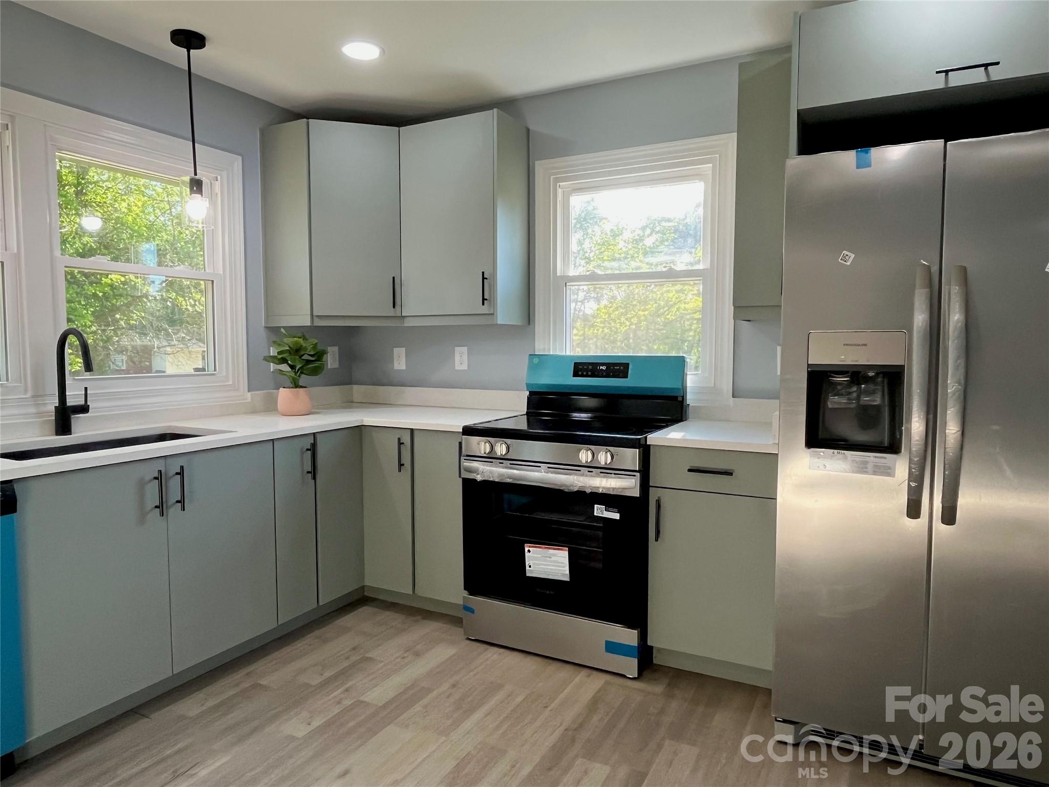 102 Arbor Court Chester, SC 29706 - Photo 15 of 42 a kitchen with stainless steel appliances granite countertop a stove a sink and a refrigerator