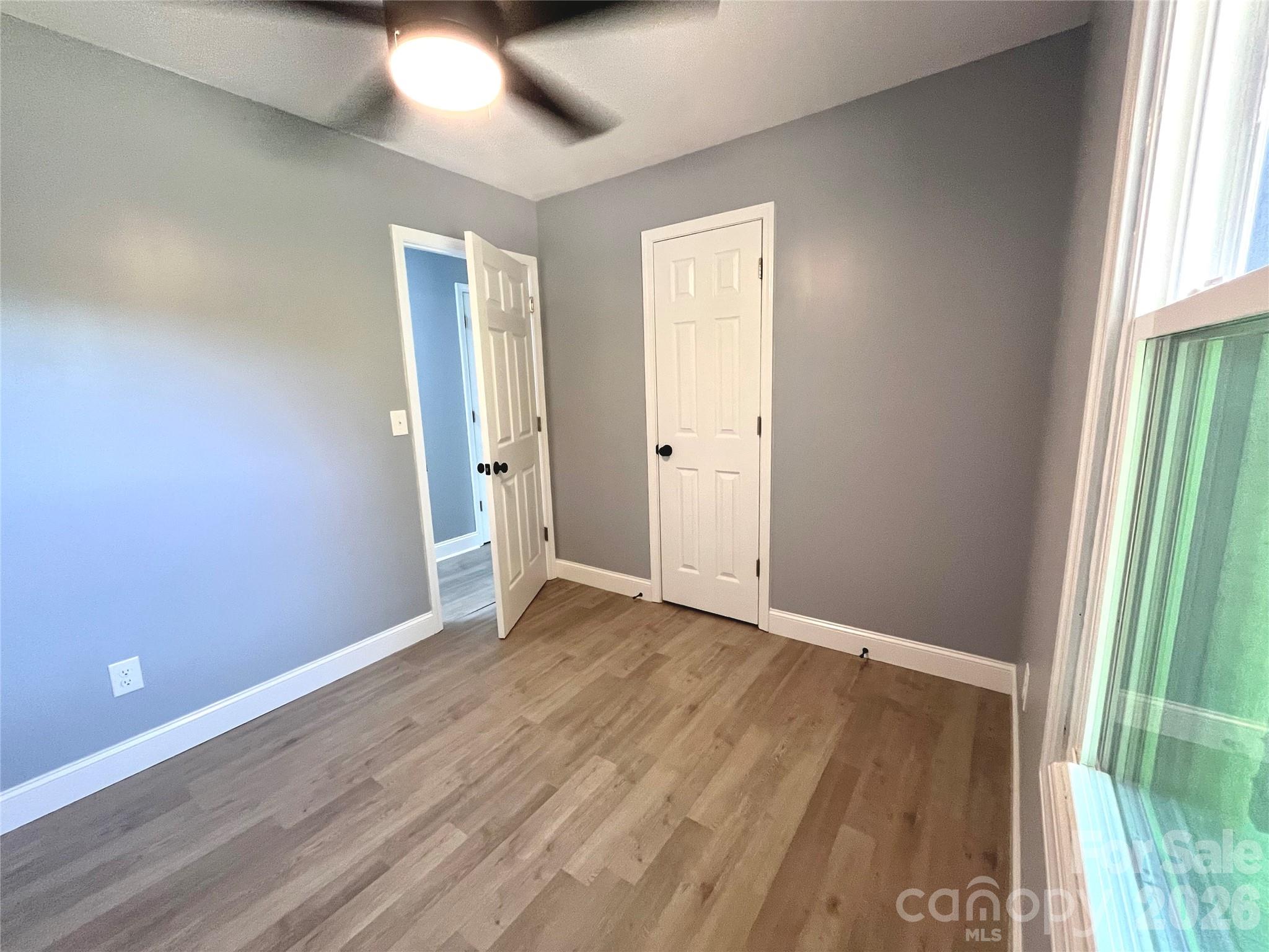 102 Arbor Court Chester, SC 29706 - Photo 25 of 42 an empty room with wooden floor and windows
