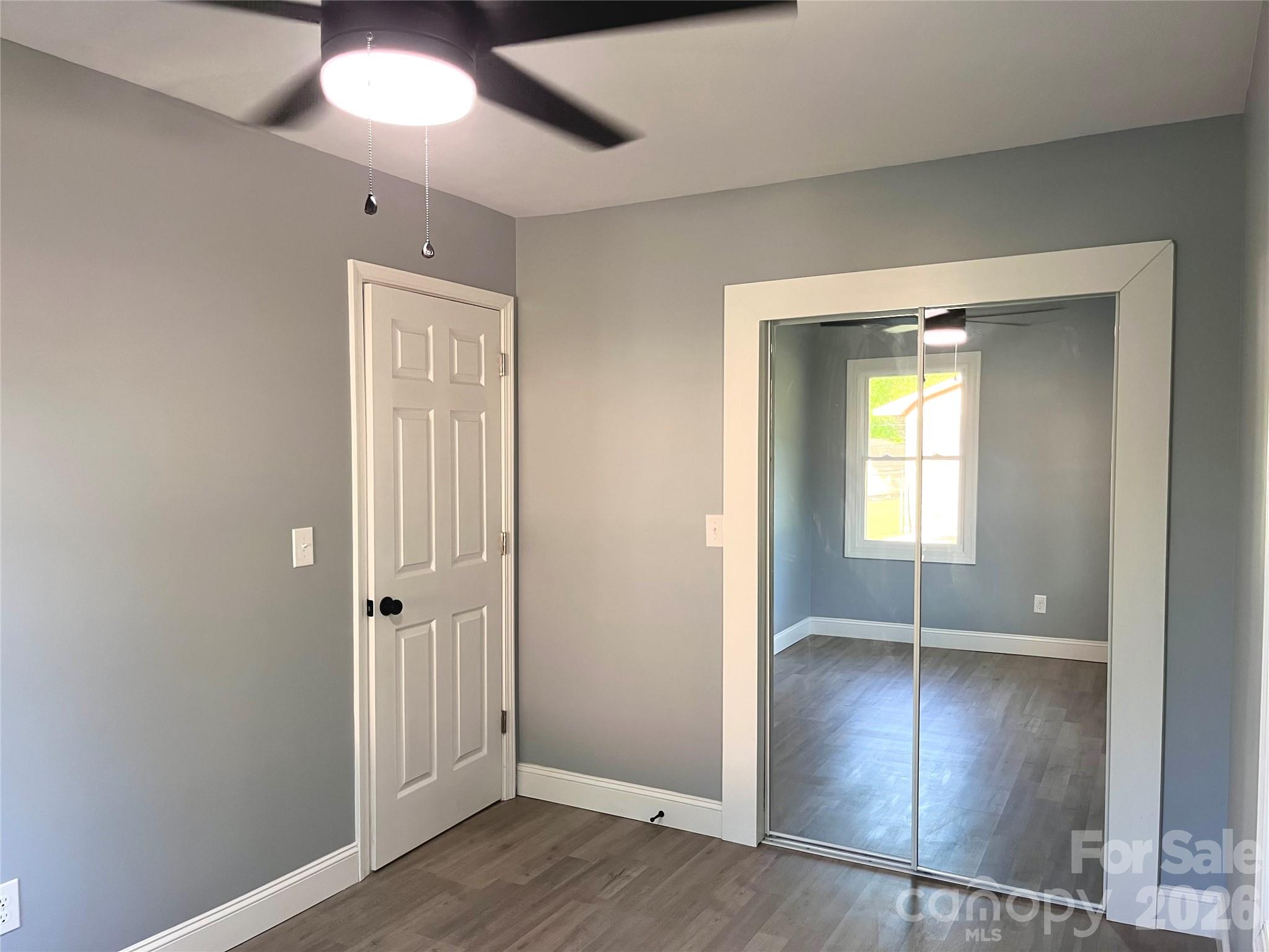 102 Arbor Court Chester, SC 29706 - Photo 30 of 42 an empty room with wooden floor and a ceiling fan