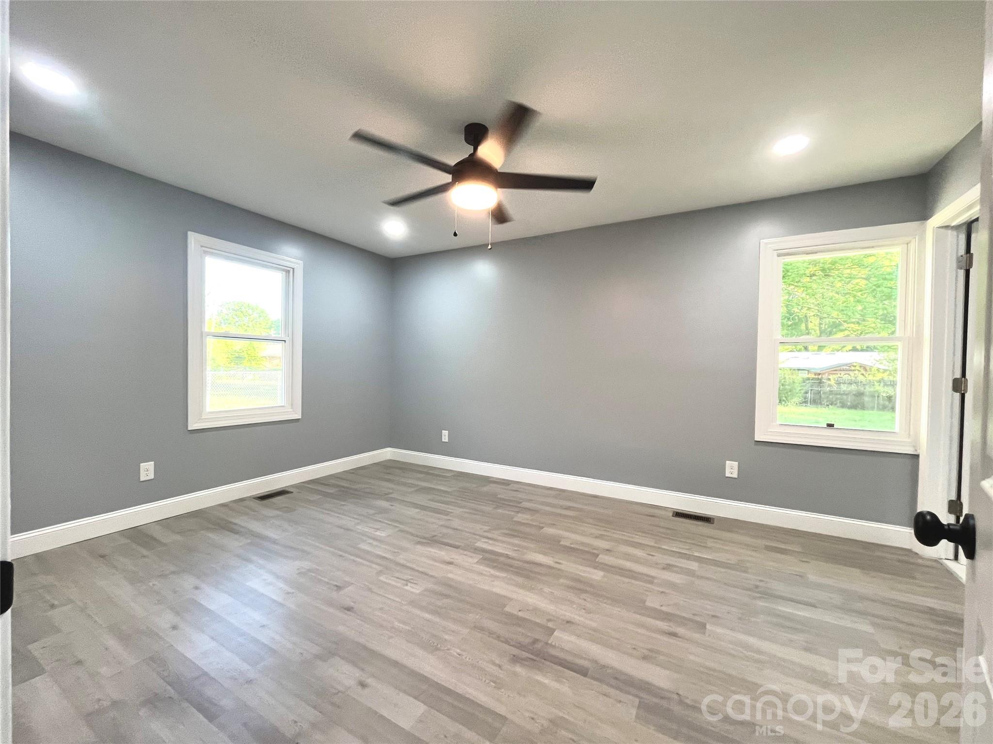 102 Arbor Court Chester, SC 29706 - Photo 31 of 42 an empty room with windows and ceiling fan