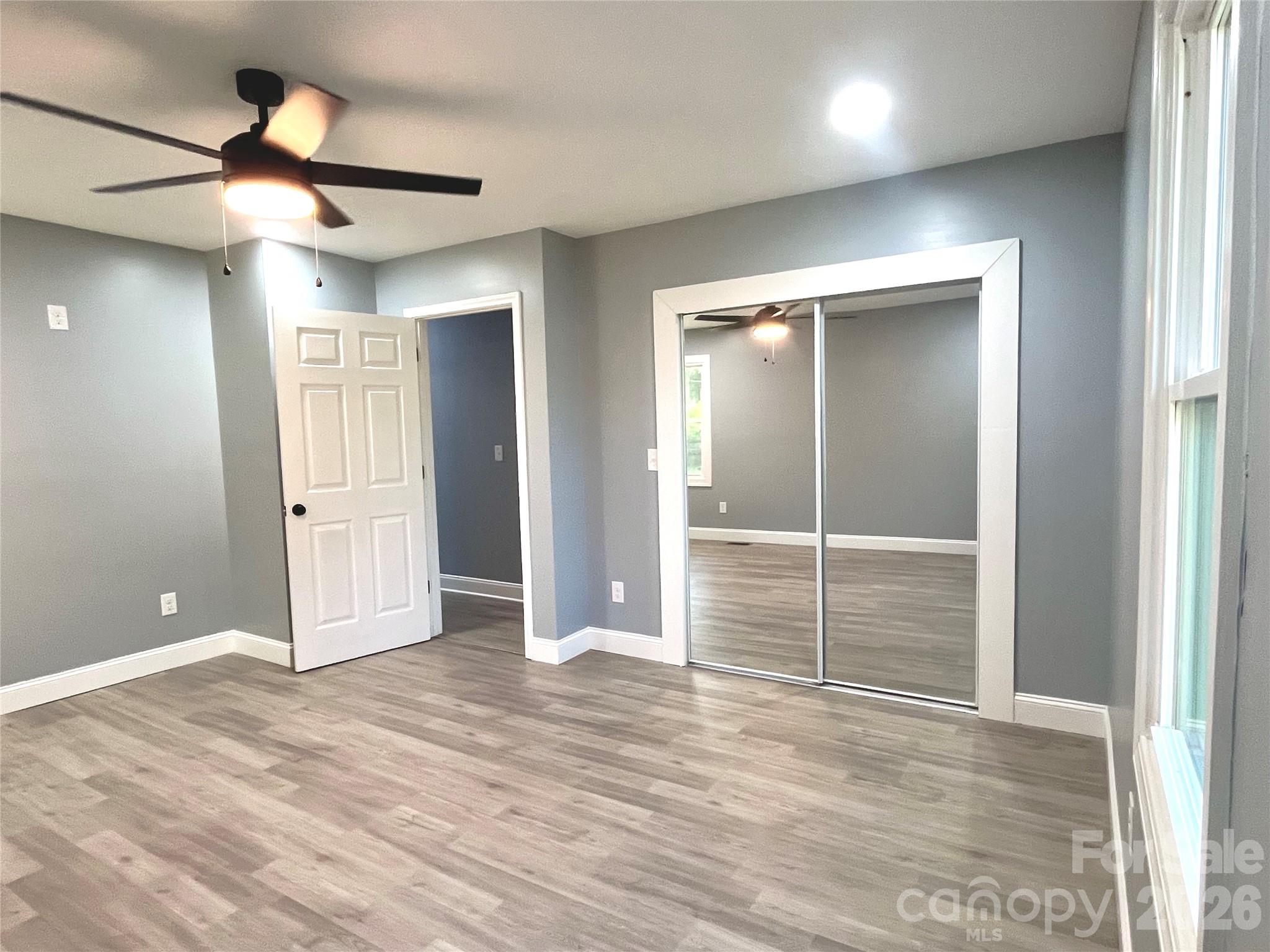 102 Arbor Court Chester, SC 29706 - Photo 32 of 42 an empty room with wooden floor and windows