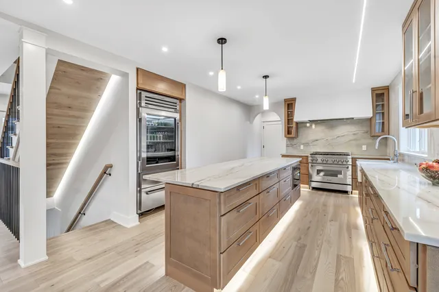 a view of empty room with kitchen and window
