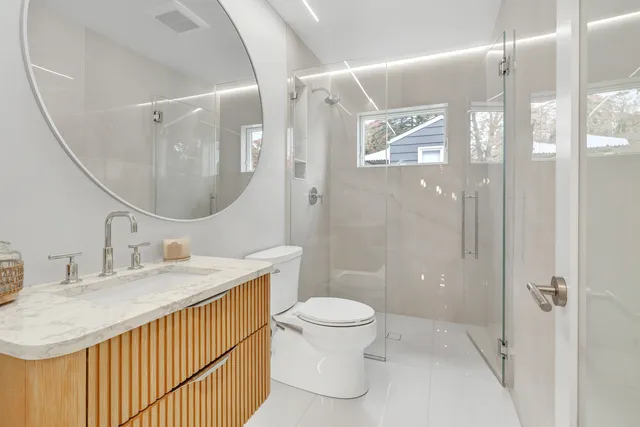 a view of an empty room with a fireplace and a window